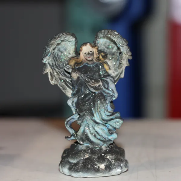 Dirty angel figurine before cleaning